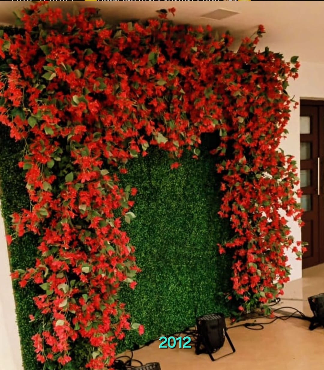 Red floral backdrop for Bengali wedding stage